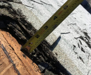 shingles removed to show multiple layers of shingles on the roof deck