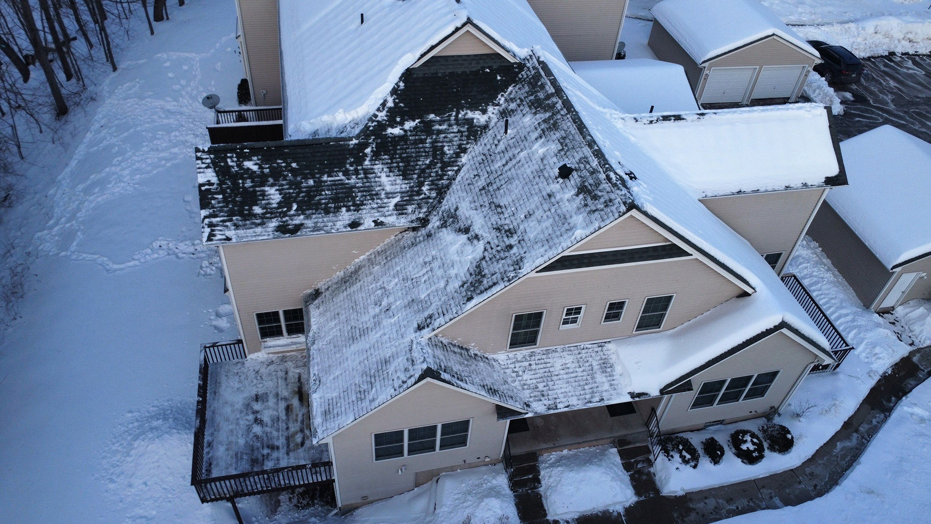overhead view of a complex roof in winter, steep pitches, multiple separate sections at different inclines